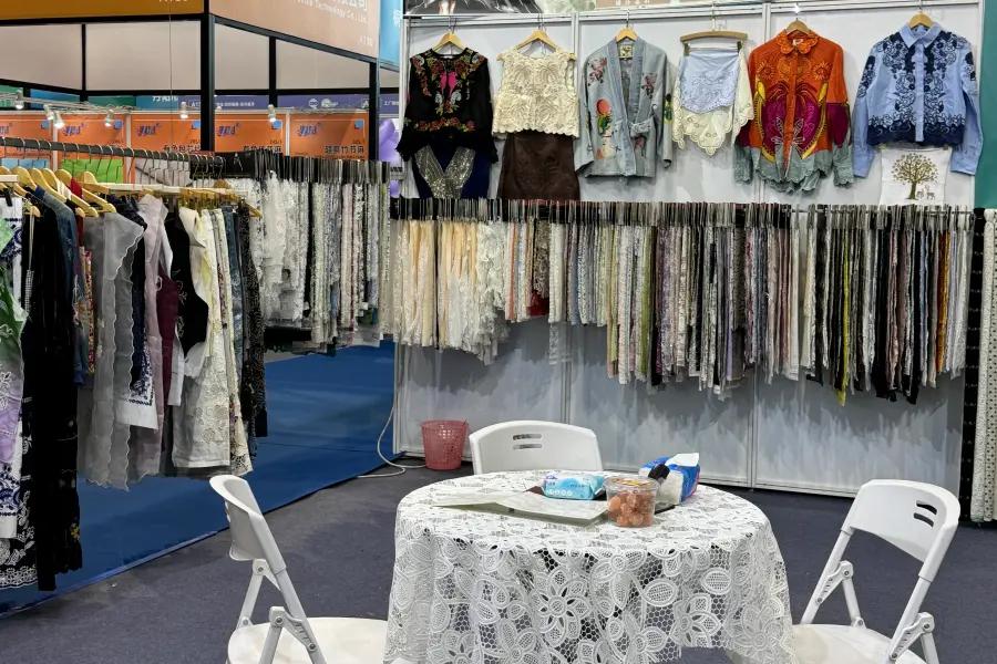 Customer examining lace fabric during an on-site visit