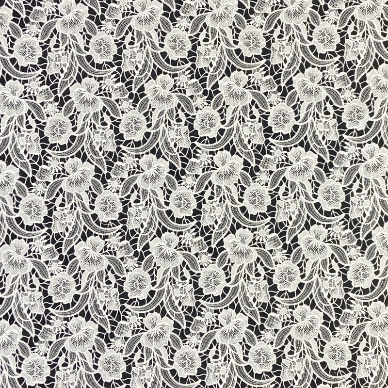 Embroidered lace with scattered motifs
