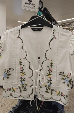 white embroidered shirt design
